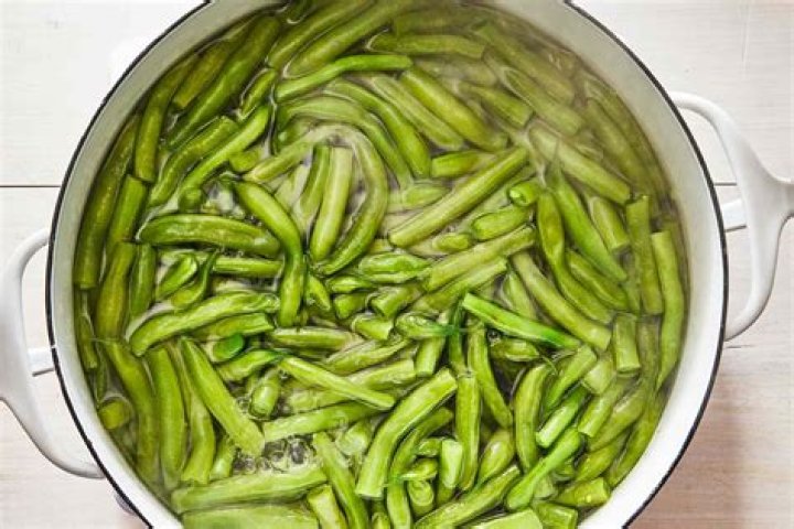 How do you add flavor to cooked green beans?