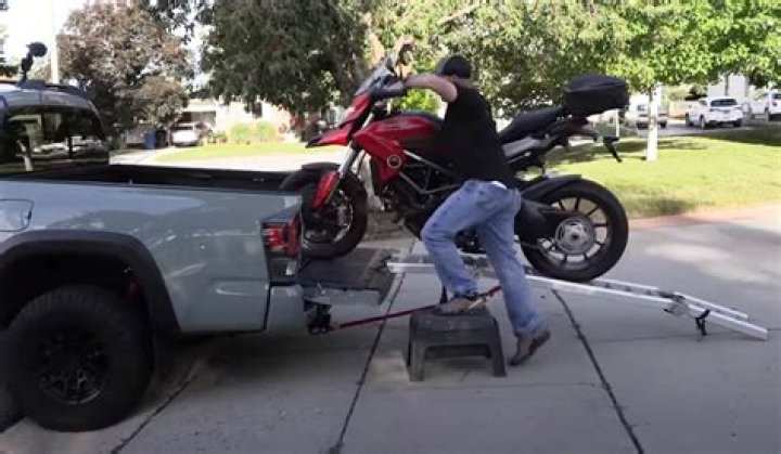 How do you lift a motorcycle on a truck?