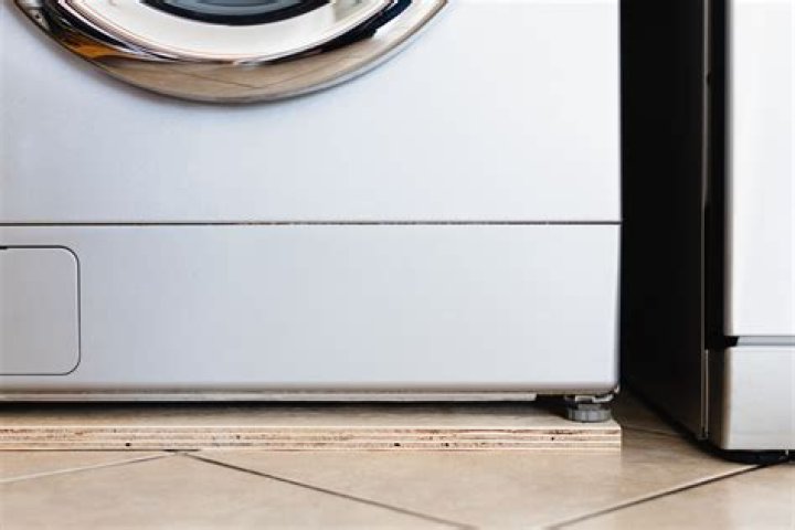 How do you stop a washing machine vibrating on a wooden floor?