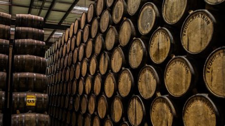 How long is anejo tequila aged in barrels?