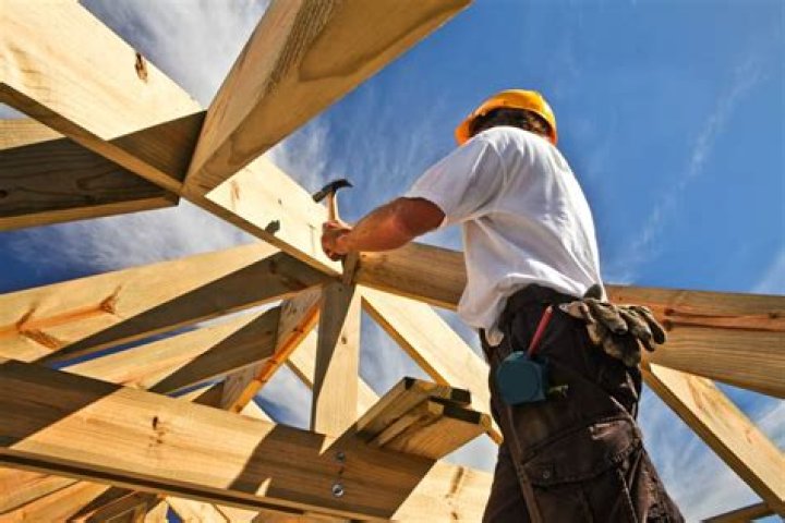 What does a carpenter do when building a house?
